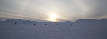 A rainbow over a body of water.