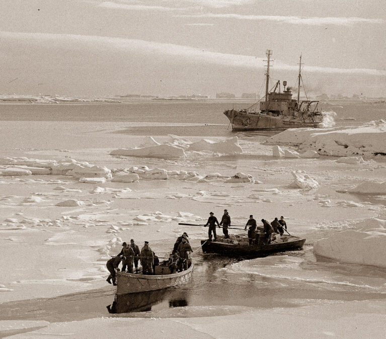 Off-loading stores. Personnel using 3 small boats to assist them in ferrying supplies ashore.Argentine Islands.