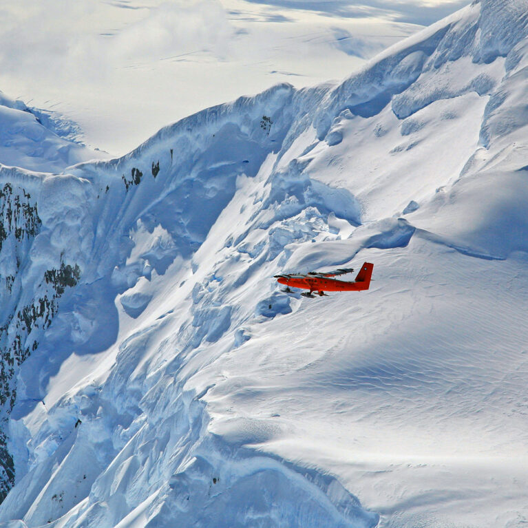A man standing on top of a snow covered mountain