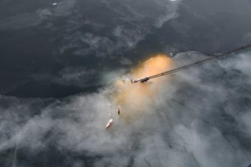 A train on a track with smoke coming out of it.