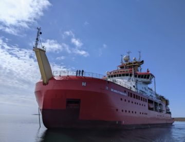The RRS Sir David Attenborough polar research ship in a body of water in Antarctica