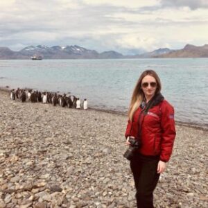 A person standing next to a body of water.