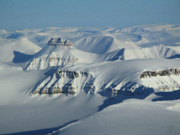 A close up of a snow covered mountain.