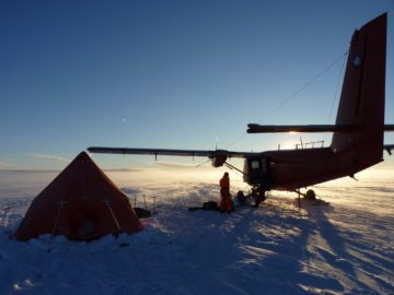 A airplane that is covered in snow.