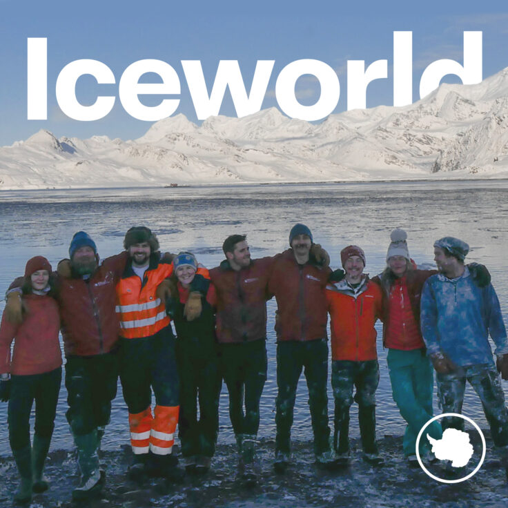 A group of people standing in front of a crowd posing for the camera