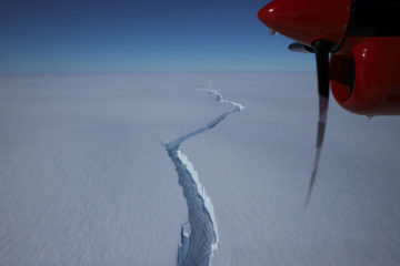 A plane flying over a body of water