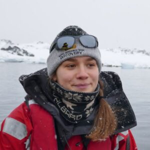 A person standing next to a body of water