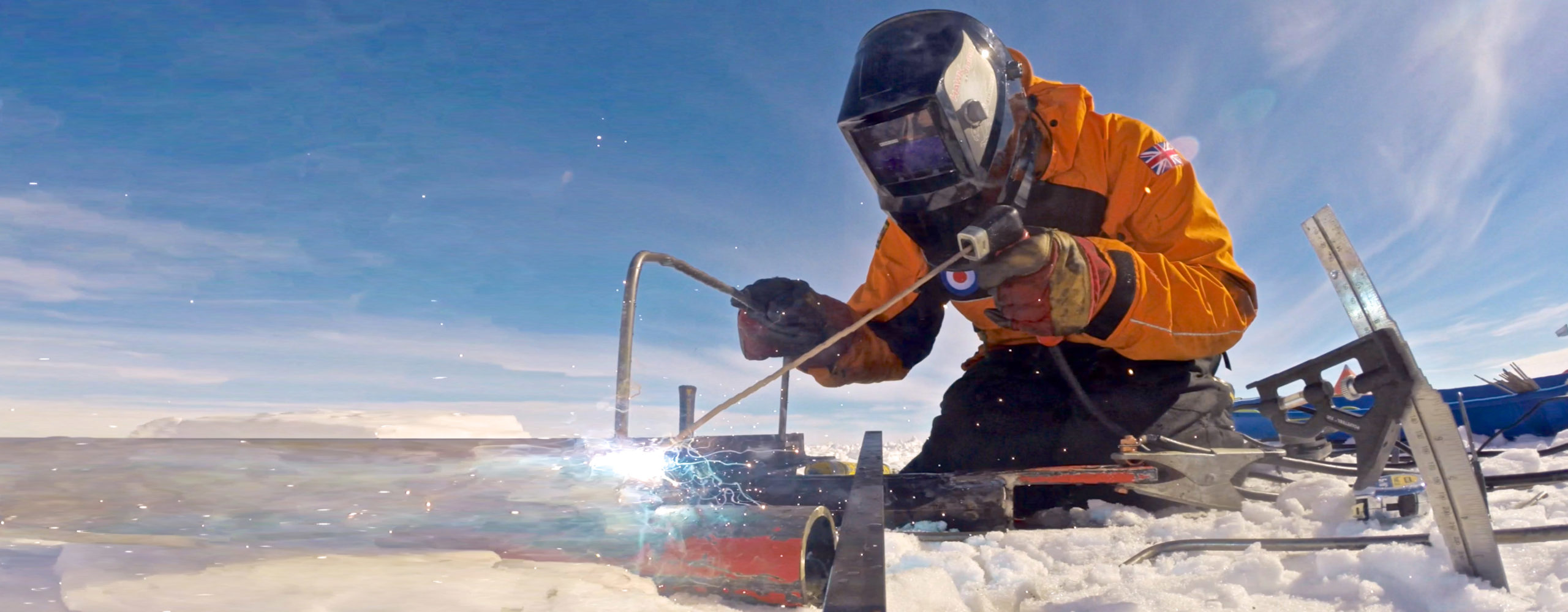 A person welding in an icy landscape