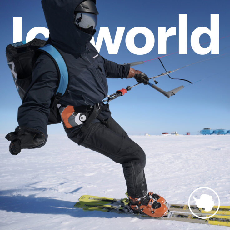 A man riding a snowboard down a snow covered slope