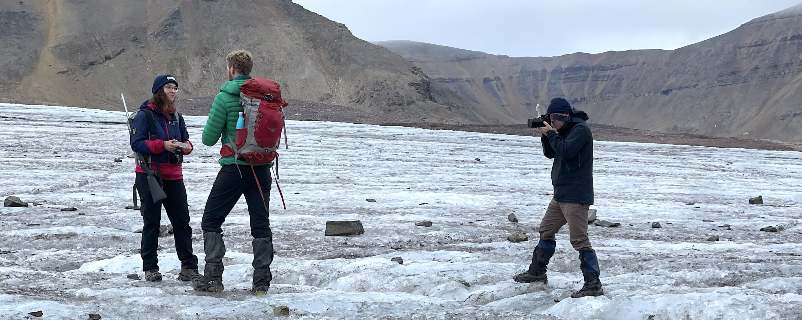 A group of people standing on top of a mountain