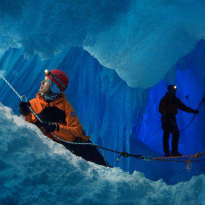 A woman and a man in an ice cave