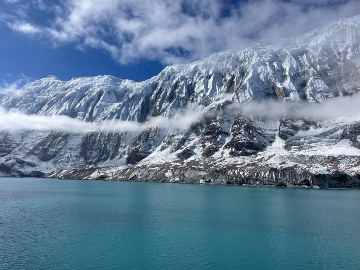 A body of water with a mountain in the background