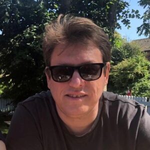 A man wearing sunglasses taking a selfie