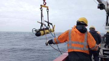 A man water skiing behind a boat.