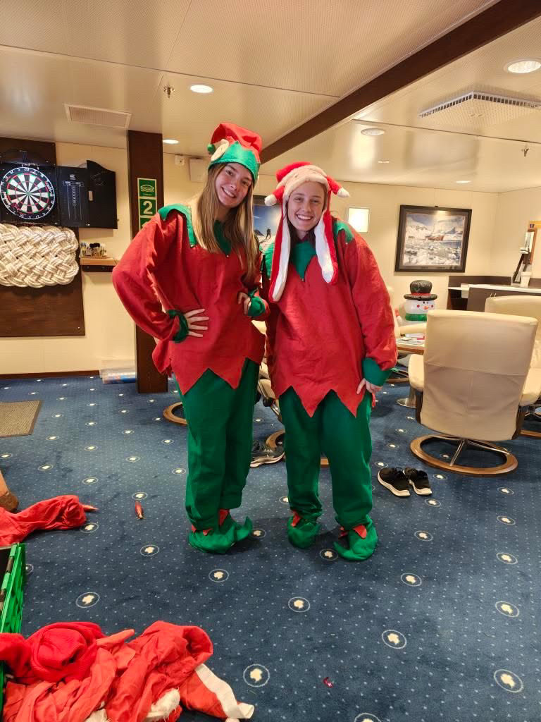 Two people wearing Christmas costumes