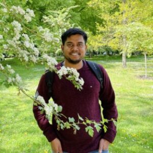 A man standing on a lush green field