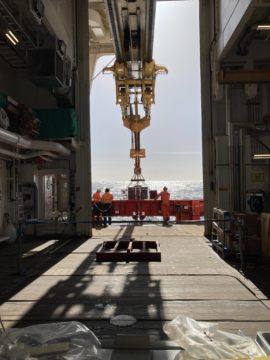 A building with a clock on the sidewalk