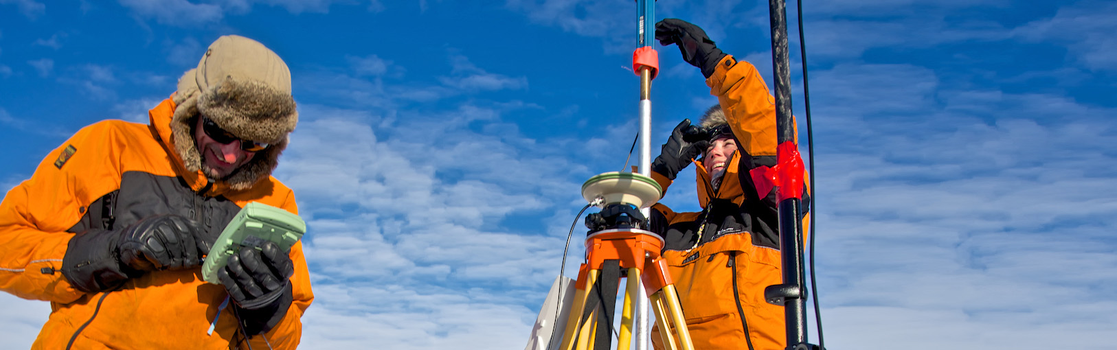 A couple of people that are standing in the snow.
