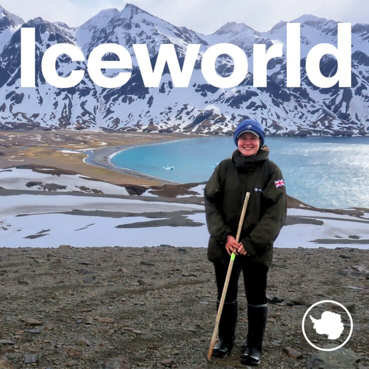 A man holding a sign posing for the camera