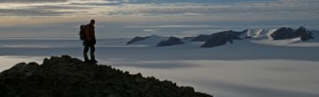 A group of people standing on top of a mountain.