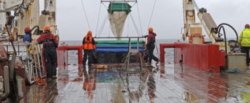 A group of people that are standing in the rain.