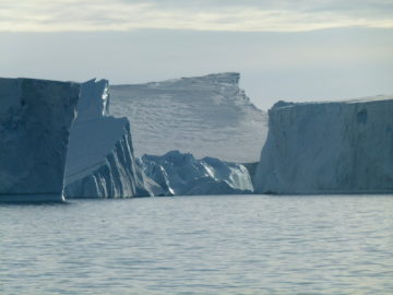 A large body of water with a mountain in the background.