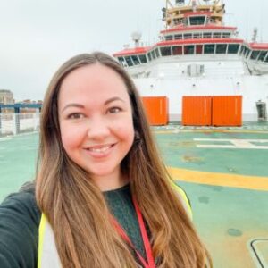 A person standing in front of a boat