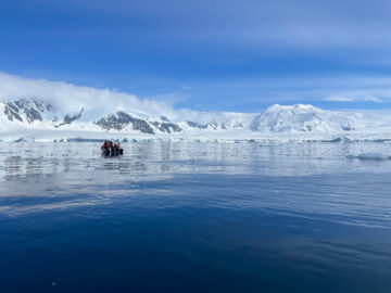 A group of people standing on top of a snow covered mountain