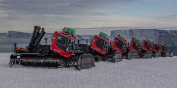 A line of PistenBullies working on the Antarctic Ice Shelf