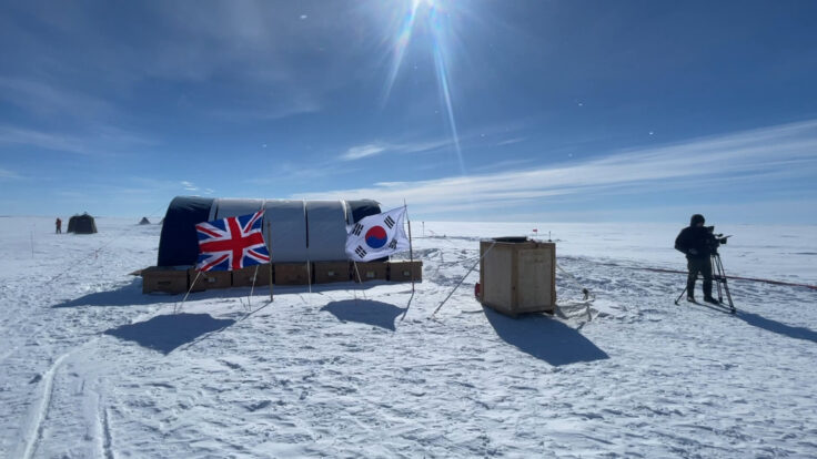A group of people flying kites in the snow