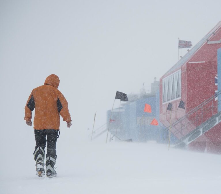 A worker walking to work during an Antarctic snow storm