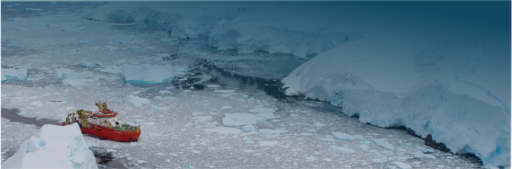 Wide angle drone image of a polar research ship breaking through packed sea ice